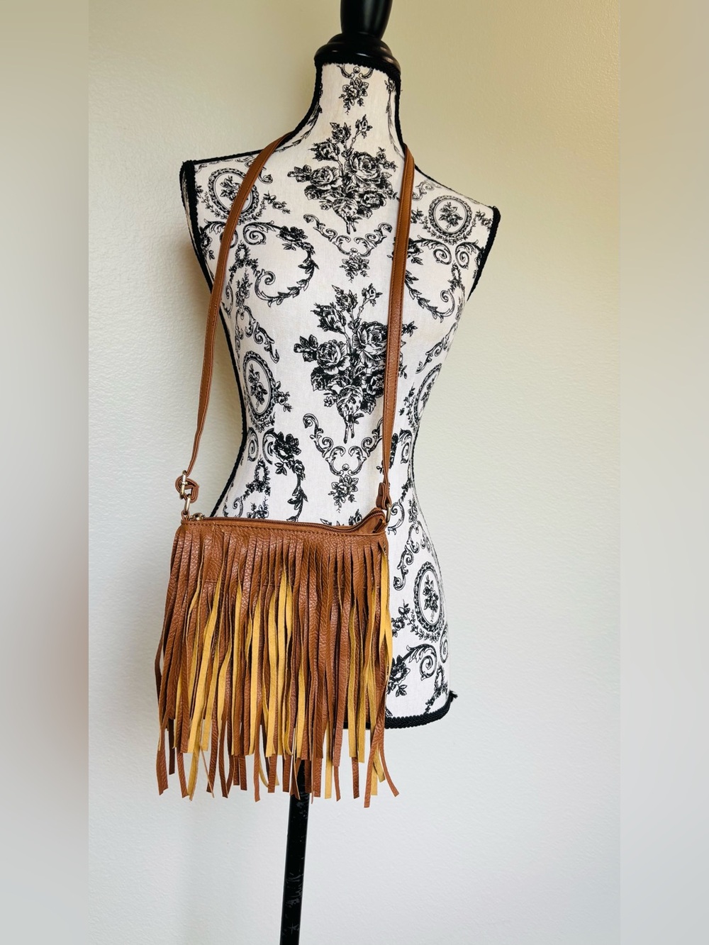Brown faux leather fringe crossbody bag with adjustable strap and zipper